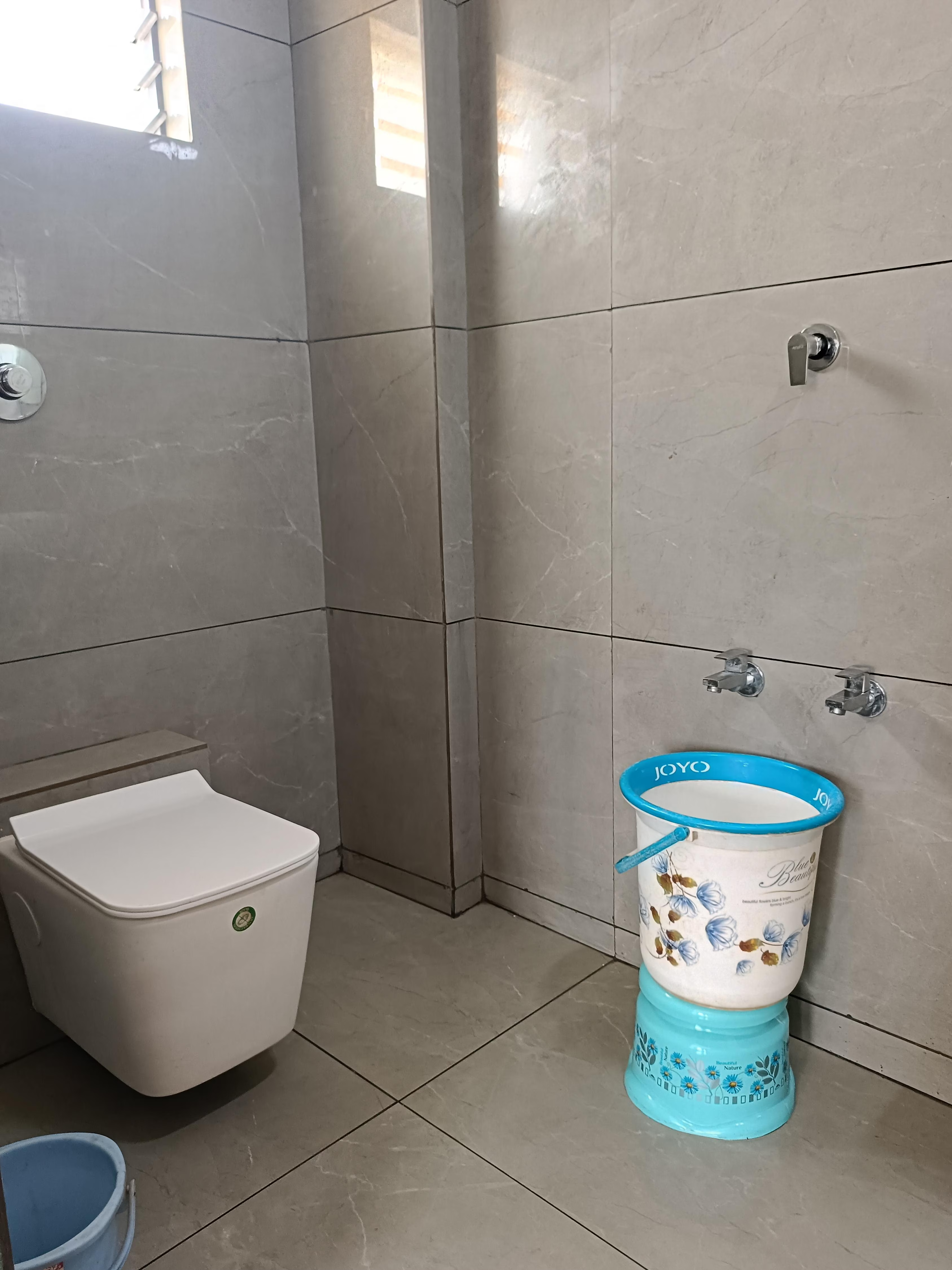 Clean and modern washroom attached to a double bed room at Hotel Somnath Atithigruh, featuring a shower and vanity.